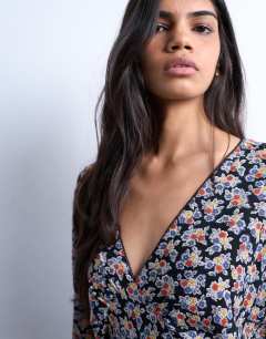 Model wearing Mini long sleeve tea dress in floral print