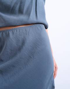 Model wearing Mixed fabric satin bias skirt in blue