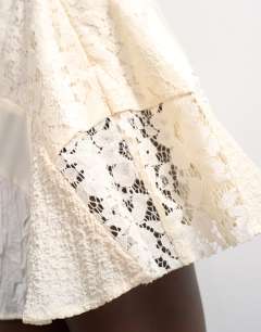 Model wearing Mixed fabric satin flippy mini skirt in ivory