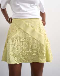 Model wearing Mixed fabric satin flippy mini skirt in soft lime
