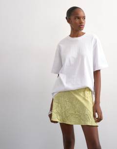 Model wearing Mixed fabric satin flippy mini skirt in soft lime