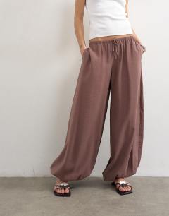Model wearing Modal balloon leg trousers in chocolate