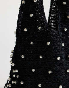 Model wearing Molly medium woven beaded bag in black