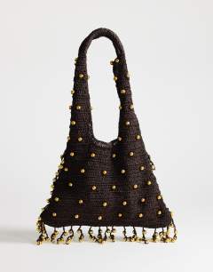 Model wearing Molly medium woven beaded bag in chocolate
