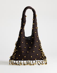 Model wearing Molly medium woven beaded bag in chocolate