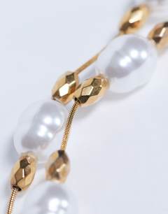 Model wearing Molly stainless steel pearl necklace in gold