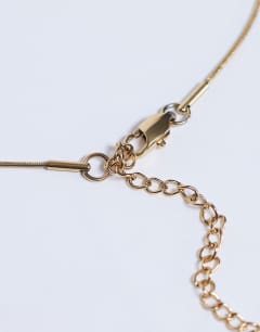 Model wearing Molly stainless steel pearl necklace in gold