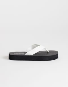 Model wearing Molly toe thong sandal in black and white