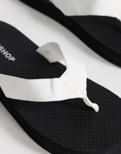 Model wearing Molly toe thong sandal in black and white