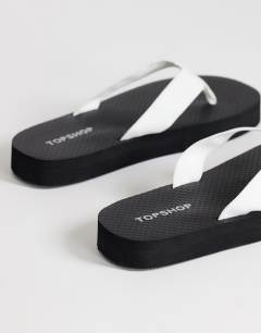 Model wearing Molly toe thong sandal in black and white