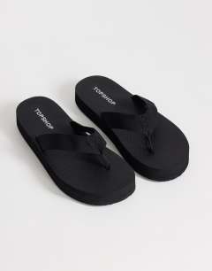Model wearing Molly toe thong sandal in black