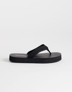 Model wearing Molly toe thong sandal in black