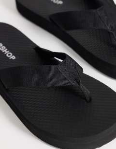 Model wearing Molly toe thong sandal in black
