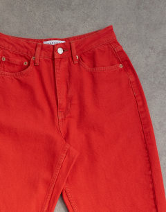 Model wearing Mom high rise loose fit jean in red