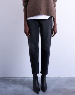 Model wearing Mom jeans in washed black