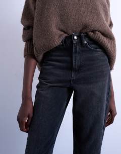 Model wearing Mom jeans in washed black