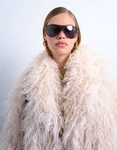 Model wearing Mongolian faux fur funnel neck mid length coat in white