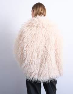 Model wearing Mongolian faux fur funnel neck mid length coat in white