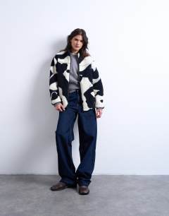 Model wearing Mono cow print borg fleece jacket in multi