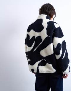 Model wearing Mono cow print borg fleece jacket in multi