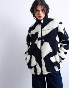 Model wearing Mono cow print borg fleece jacket in multi
