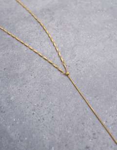 Model wearing Morgan stainless steel twisted long chain necklace in gold