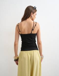 Model wearing Multi beaded strap vest in black