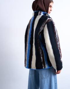 Model wearing Multi stripe borg fleece jacket in white stripe