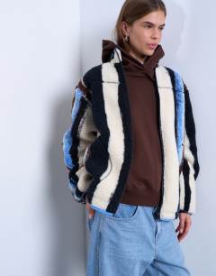 Model wearing Multi stripe borg fleece jacket in white stripe