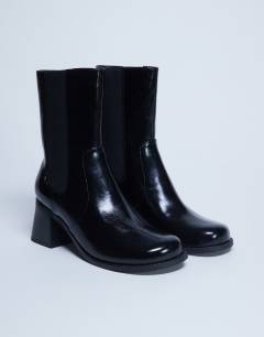 Model wearing Myra block heel chelsea boot in black