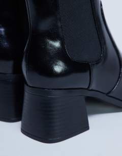 Model wearing Myra block heel chelsea boot in black