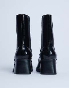 Model wearing Myra block heel chelsea boot in black