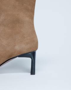 Model wearing Nadie real suede chisel toe ankle boot in beige