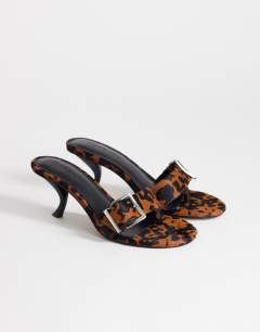 Model wearing Nadine real hair on leather mid heeled mule with buckle in leopard print