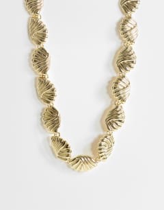 Model wearing Naleigh swirl necklace in gold
