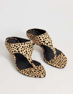 Model wearing Nancy toe thong mid heel sandal in caramel dalmatian print hair on real leather 