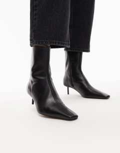 Model wearing Narla premium real leather high pin heeled ankle boots in black