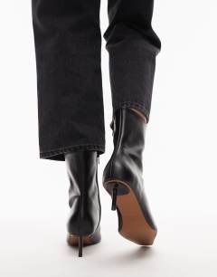 Model wearing Narla premium real leather high pin heeled ankle boots in black