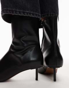 Model wearing Narla premium real leather high pin heeled ankle boots in black