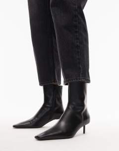 Model wearing Narla premium real leather high pin heeled ankle boots in black