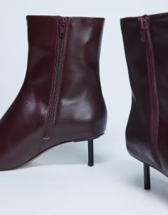 Model wearing Narla premium real leather high pin heeled ankle boots in burgundy