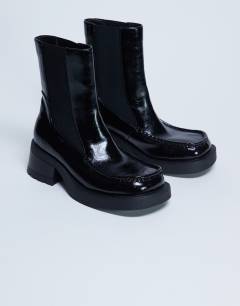 Model wearing Narla square toe chelsea boot in black