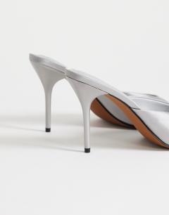 Model wearing Nasim high heeled mule in grey satin