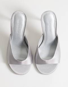 Model wearing Nasim high heeled mule in grey satin