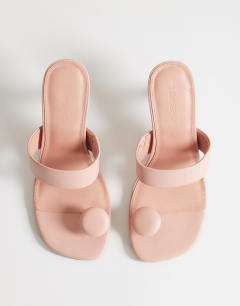 Model wearing Natalie toe thong angular mid heel sandal in pink