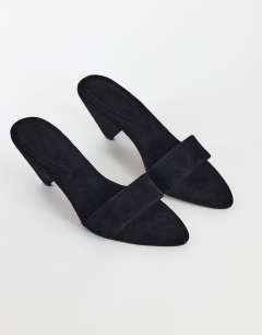 Model wearing Nathan cone heel mule in black faux suede