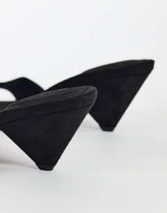 Model wearing Nathan cone heel mule in black faux suede