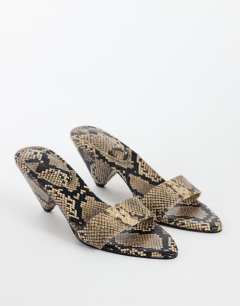 Model wearing Nathan cone heel mule in snake print