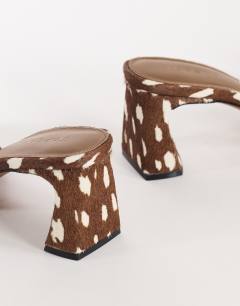 Model wearing Nela mid heel mule in brown deer print hair on real leather