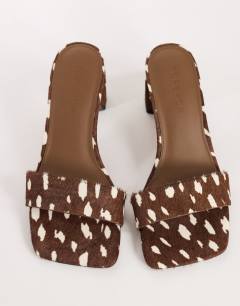 Model wearing Nela mid heel mule in brown deer print hair on real leather